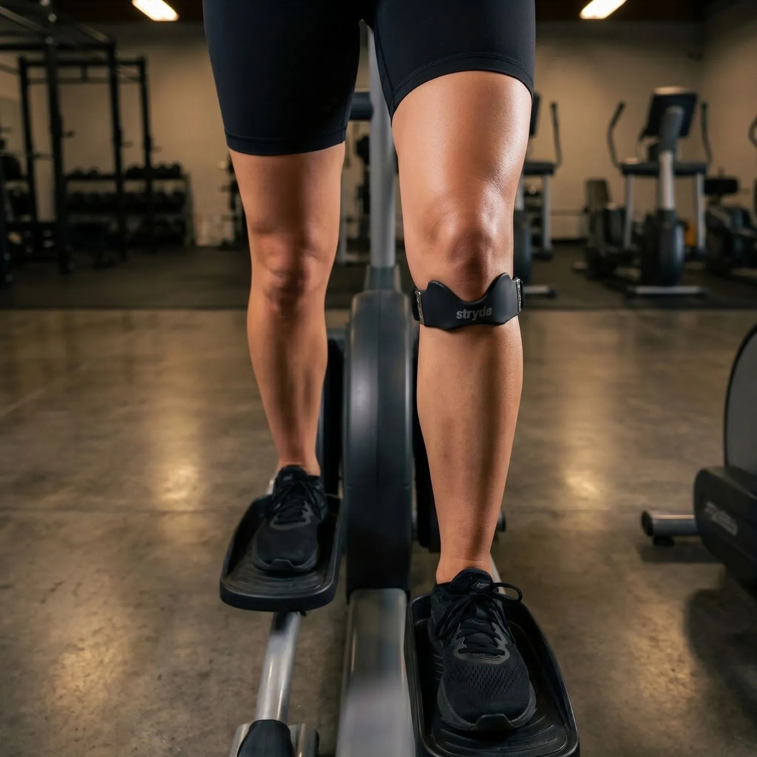 Athlete wearing the Stryde Precision Strap during a stationary bike workout