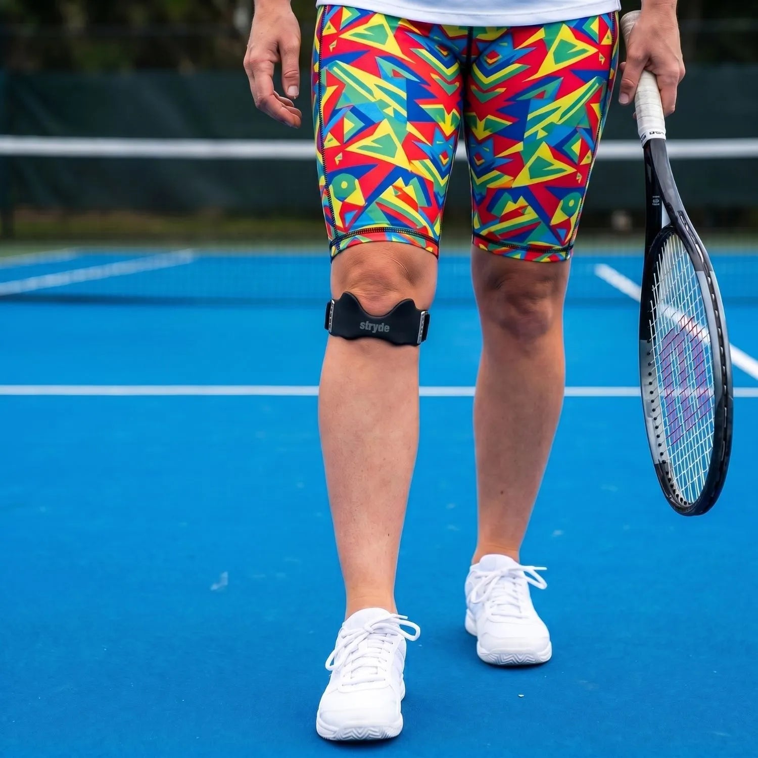 Megan playing tennis while wearing Stryde